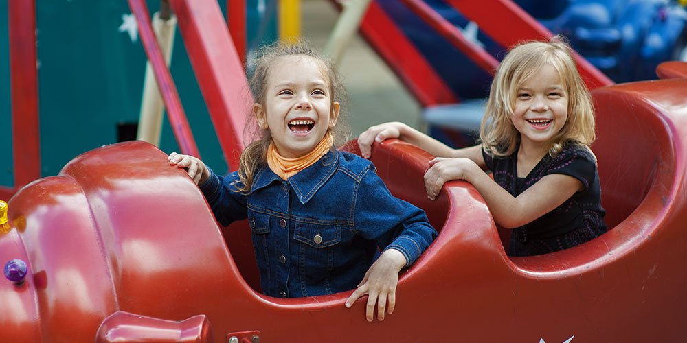 Happy children on ride to increase season pass sales